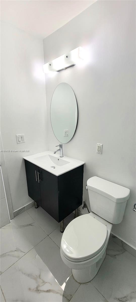 14004 Southwest 259th Street, Unit 14004 Homestead, FL 33032 - Photo 21 of 38 a bathroom with a toilet a sink and mirror