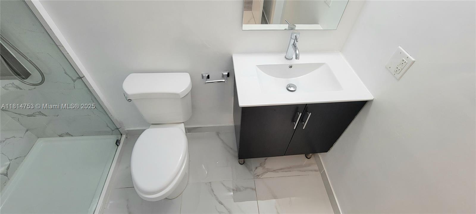 14004 Southwest 259th Street, Unit 14004 Homestead, FL 33032 - Photo 26 of 38 a bathroom with a sink toilet and vanity