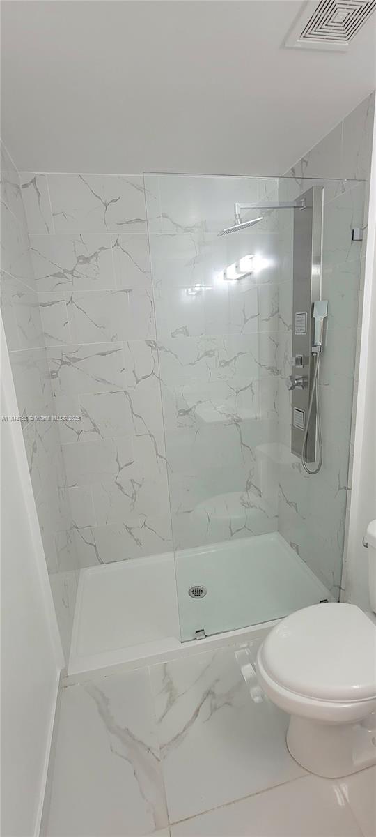14004 Southwest 259th Street, Unit 14004 Homestead, FL 33032 - Photo 27 of 38 a bathroom with a bathtub and a toilet