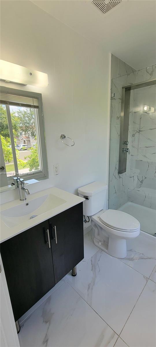 14004 Southwest 259th Street, Unit 14004 Homestead, FL 33032 - Photo 30 of 38 a bathroom with a sink a toilet and shower