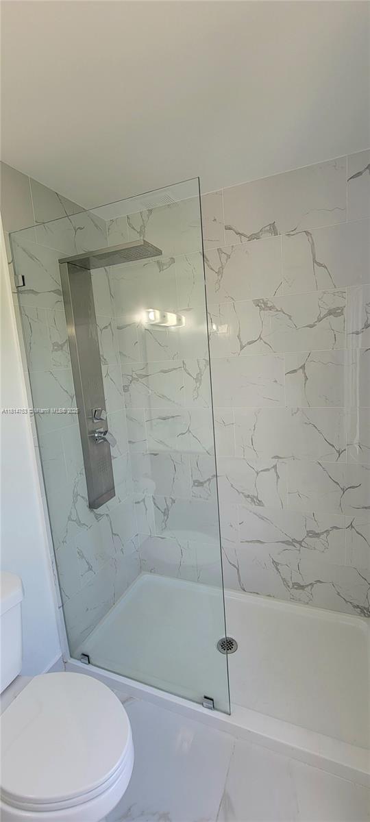 14004 Southwest 259th Street, Unit 14004 Homestead, FL 33032 - Photo 31 of 38 a bathroom with a toilet and a shower