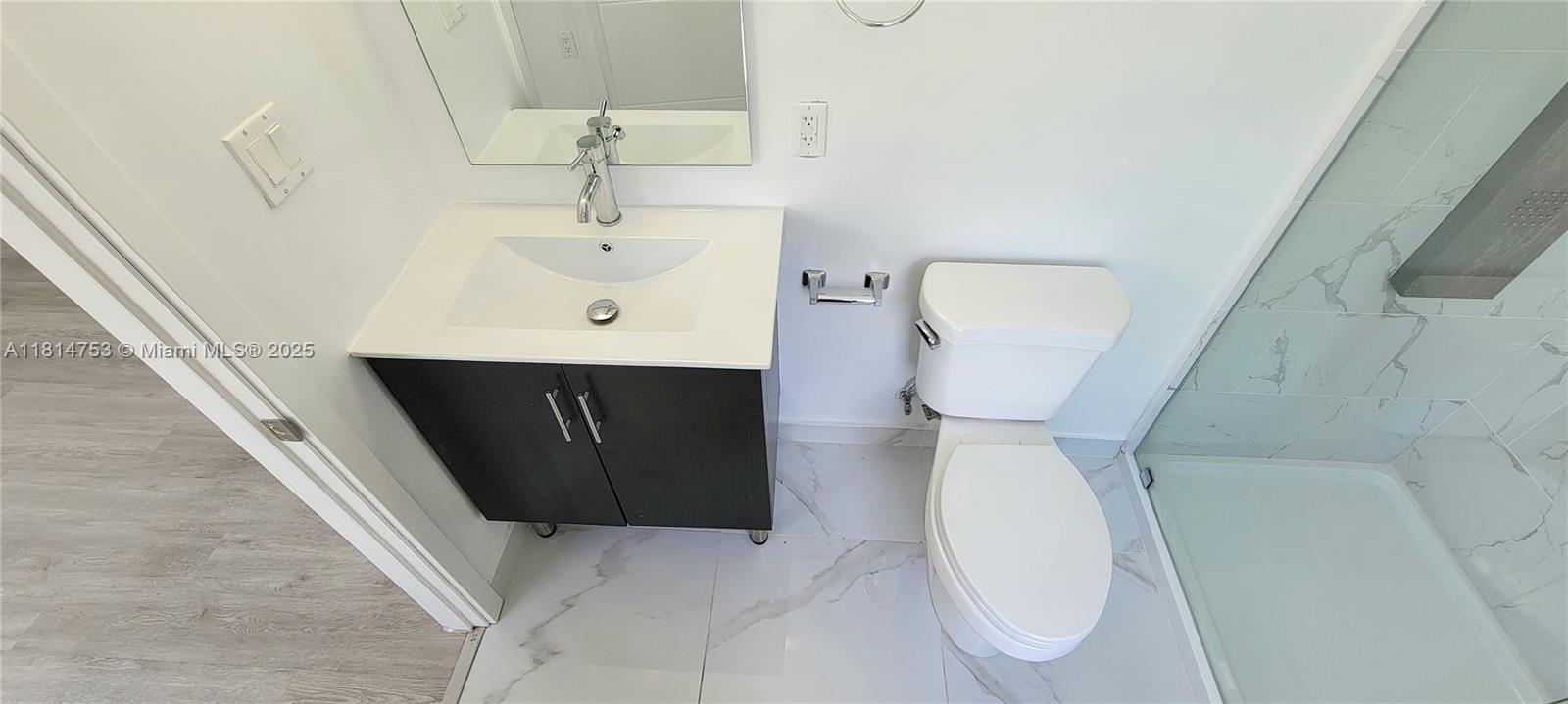 14004 Southwest 259th Street, Unit 14004 Homestead, FL 33032 - Photo 32 of 38 a bathroom with a sink and mirror