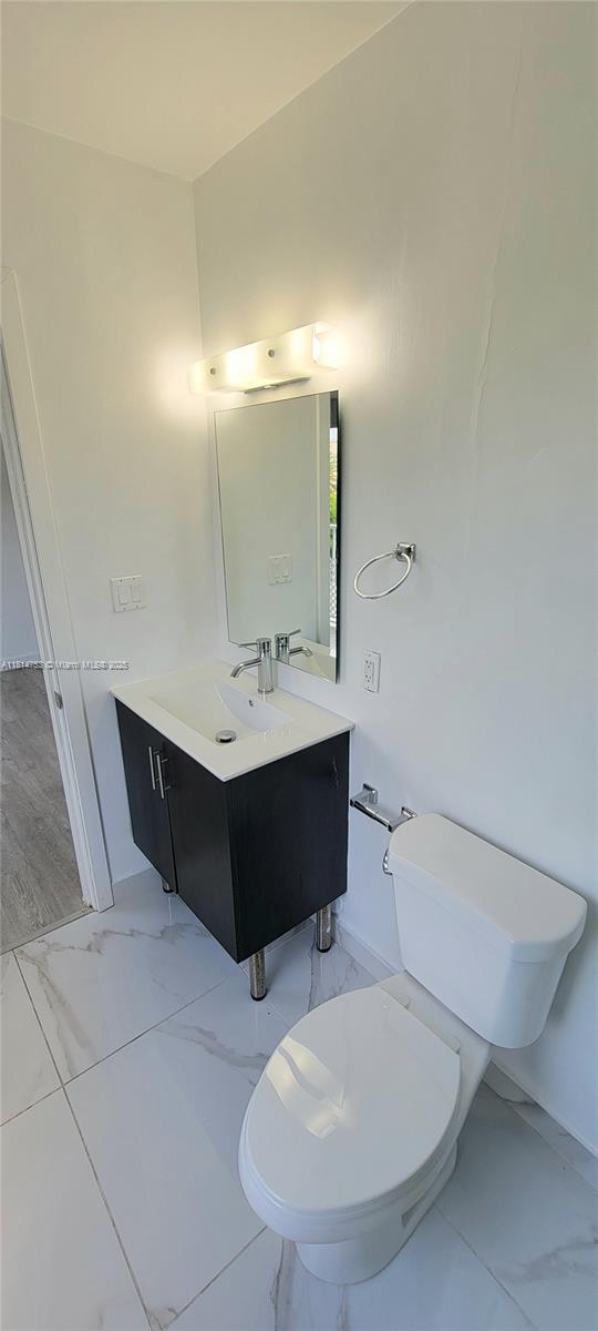 14004 Southwest 259th Street, Unit 14004 Homestead, FL 33032 - Photo 33 of 38 a bathroom with a sink toilet and mirror