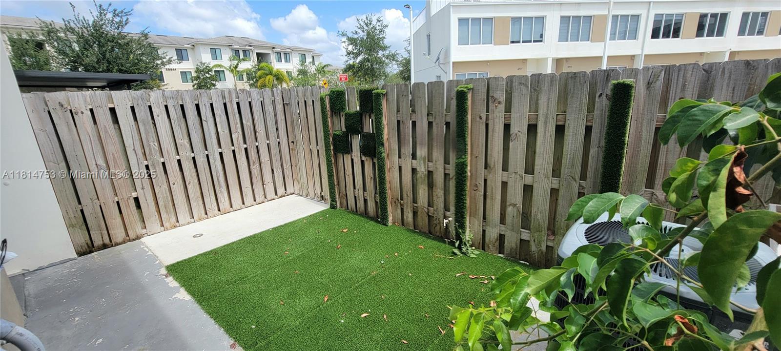 14004 Southwest 259th Street, Unit 14004 Homestead, FL 33032 - Photo 36 of 38 a view of a backyard with wooden fence