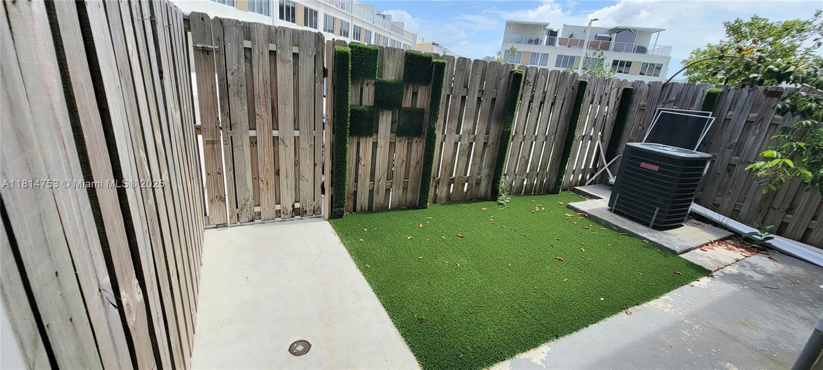 14004 Southwest 259th Street, Unit 14004 Homestead, FL 33032 - Photo 37 of 38 a view of a backyard with wooden fence