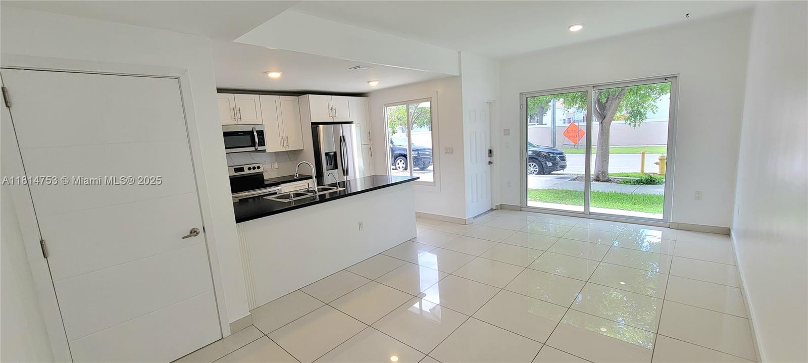 14004 Southwest 259th Street, Unit 14004 Homestead, FL 33032 - Photo 5 of 38 a view of a kitchen with a refrigerator and a sink