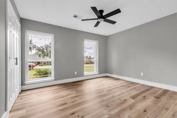 wooden floor in an empty room with a window