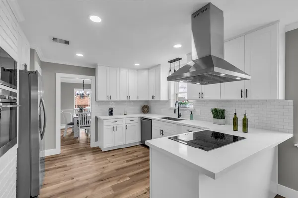 a kitchen with a stove a sink and a refrigerator