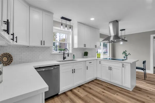 a kitchen with a sink cabinets and window