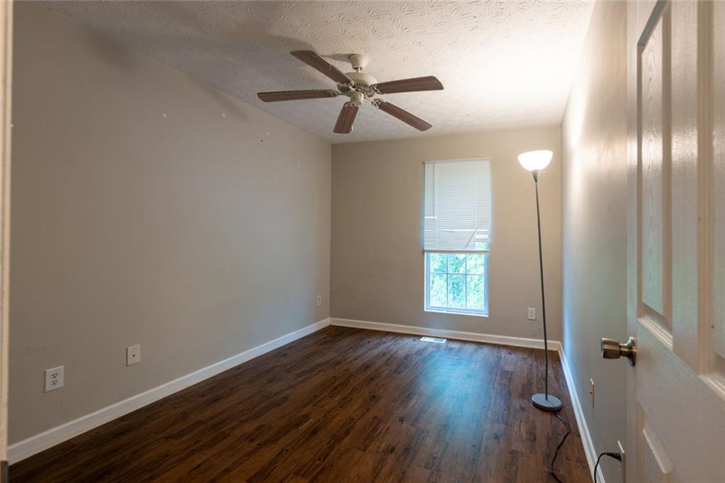 3474 Waldrop Trail Decatur, GA 30034 - Photo 11 of 17 an empty room with wooden floor fan and windows