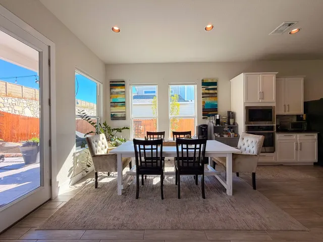 a view of a dining room with furniture window and outside view