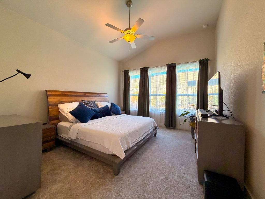 11001 Charger Way Manor, TX 78653 - Photo 17 of 36 a bedroom with a bed and a chandelier