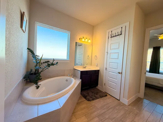 a bathroom with a tub and a sink