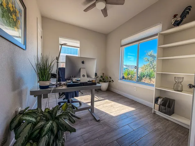 a workspace with furniture window and wooden floor