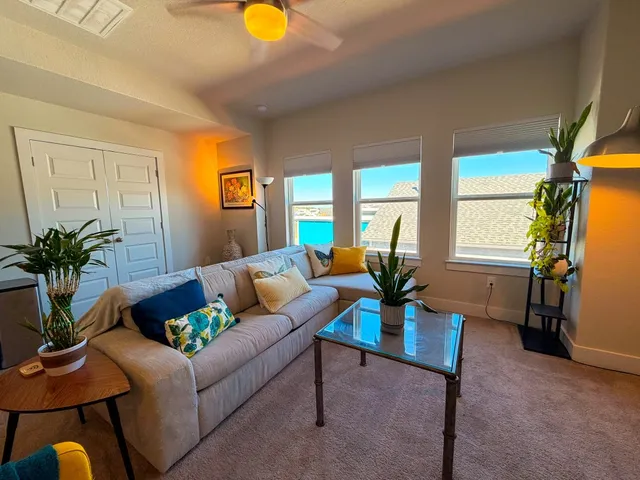 a living room with furniture flowerpot and a window