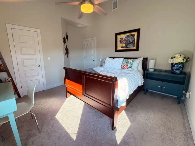 a bed room with a bed and a lamp on table