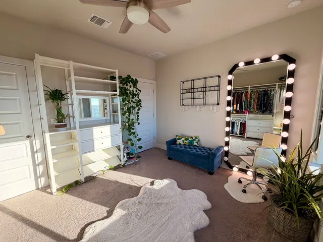 a living room with furniture flowerpot and a chandelier