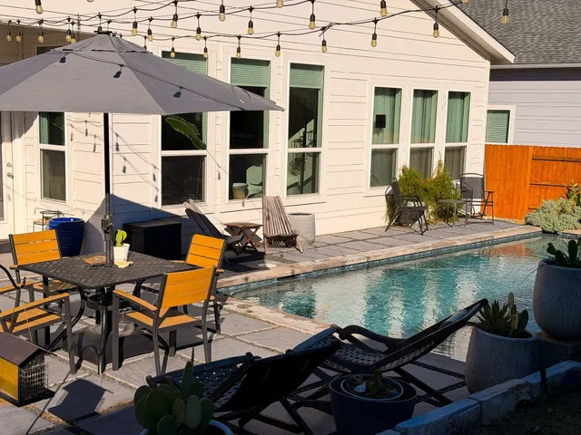 a view of a patio with table and chairs and potted plants