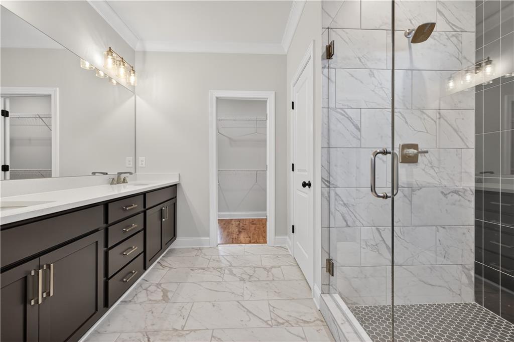 3787 Cheyenne Lane Jefferson, GA 30549 - Photo 43 of 82 a spacious bathroom with a double vanity sink a shower and a mirror