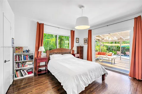 a large bedroom with a bed and a large window