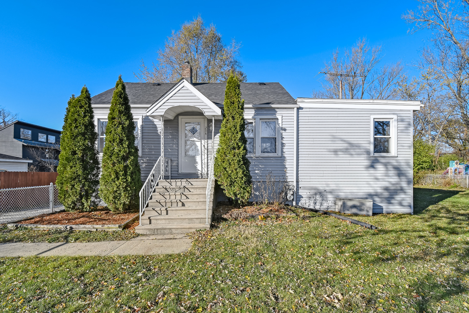 254 Village Road Willowbrook, IL 60527 - Photo 1 of 15 a front view of a house with a garden