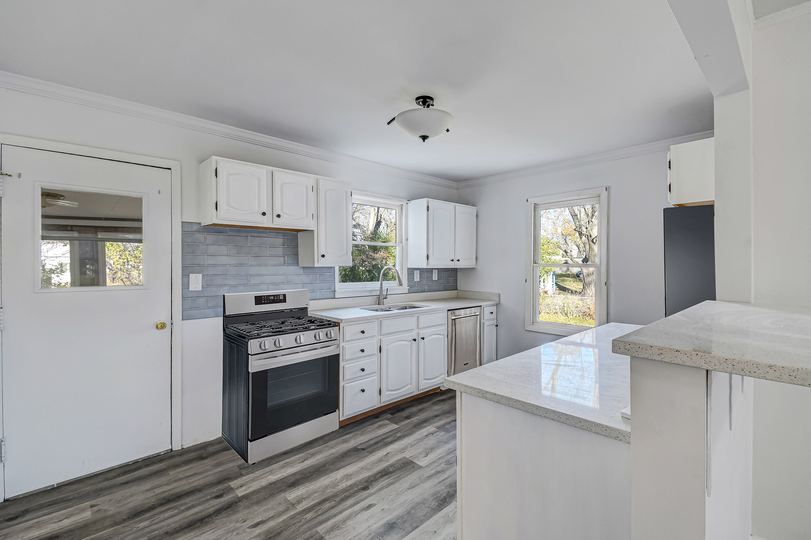 254 Village Road Willowbrook, IL 60527 - Photo 5 of 15 a kitchen with granite countertop white cabinets and stainless steel appliances