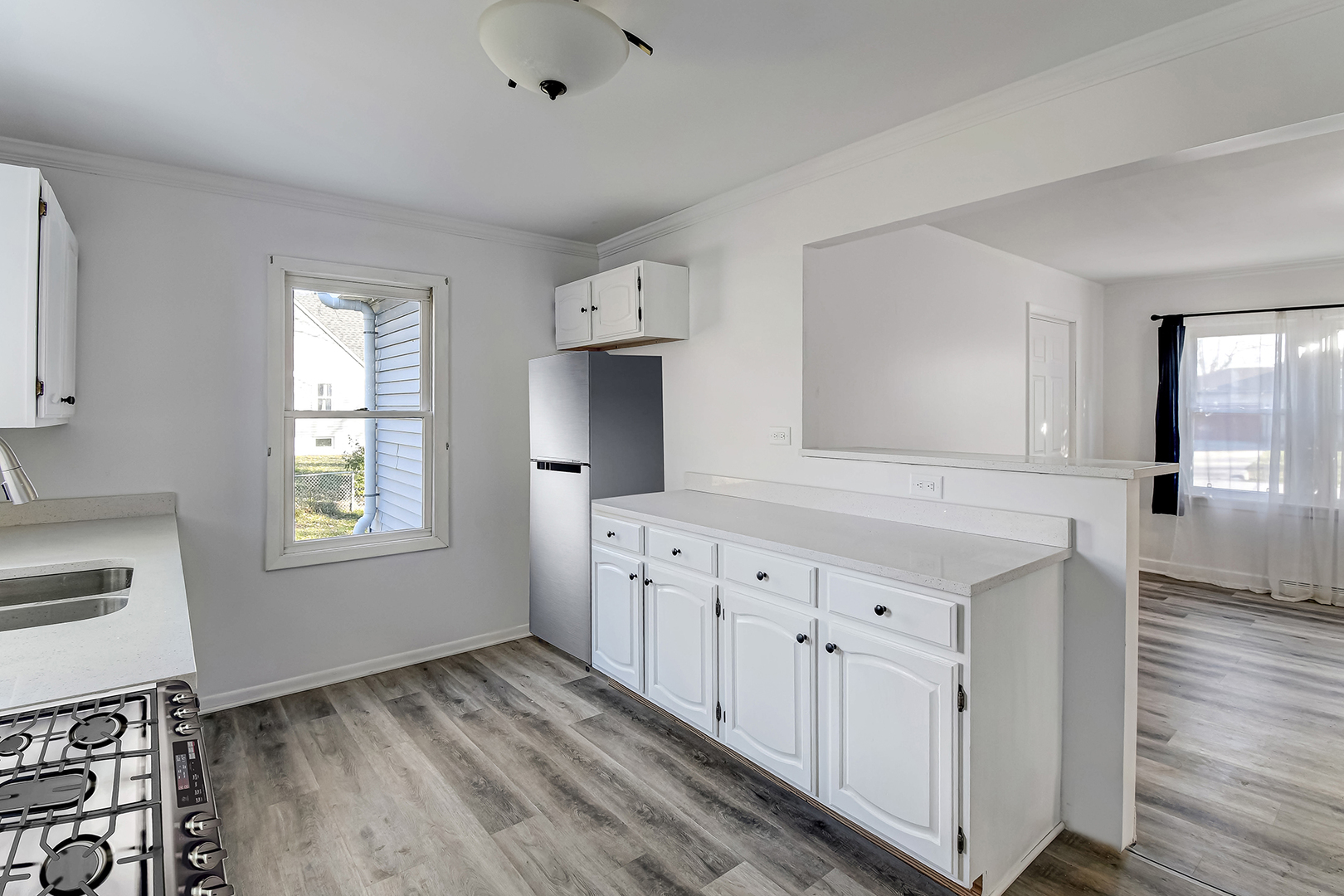 254 Village Road Willowbrook, IL 60527 - Photo 6 of 15 a room with white cabinets and wooden floors
