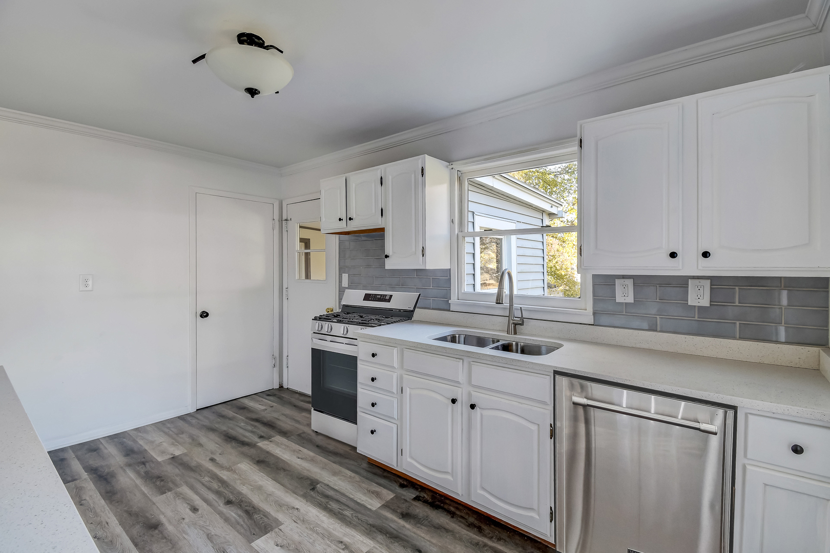 254 Village Road Willowbrook, IL 60527 - Photo 7 of 15 a kitchen with a sink stove and cabinets