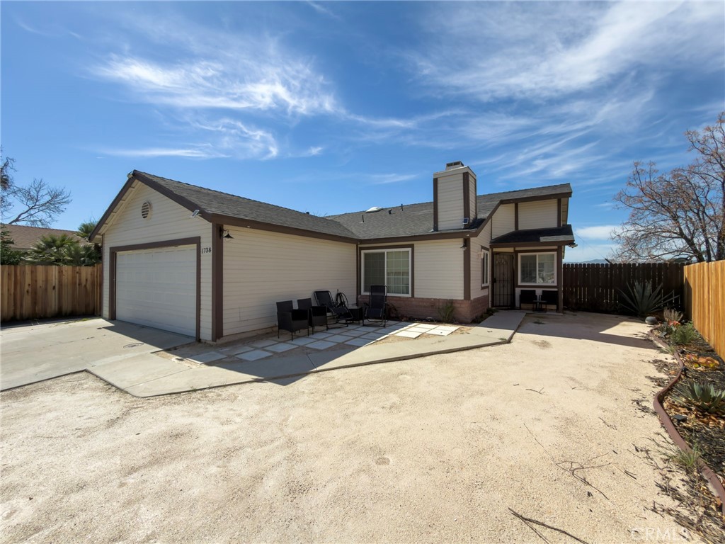 1738 The Willows Road San Jacinto, CA 92583 - Photo 2 of 34 a view of a house with backyard and a garage