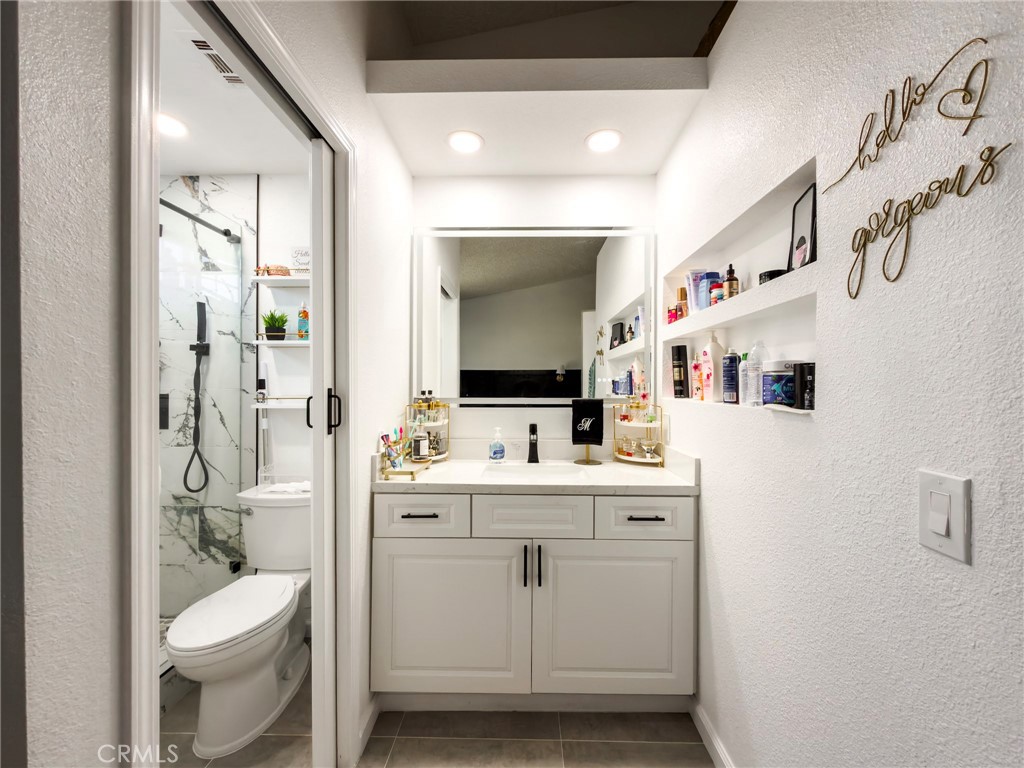1738 The Willows Road San Jacinto, CA 92583 - Photo 22 of 34 a bathroom with a sink toilet and mirror