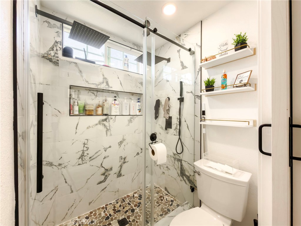1738 The Willows Road San Jacinto, CA 92583 - Photo 23 of 34 a bathroom with a shower toilet and sink