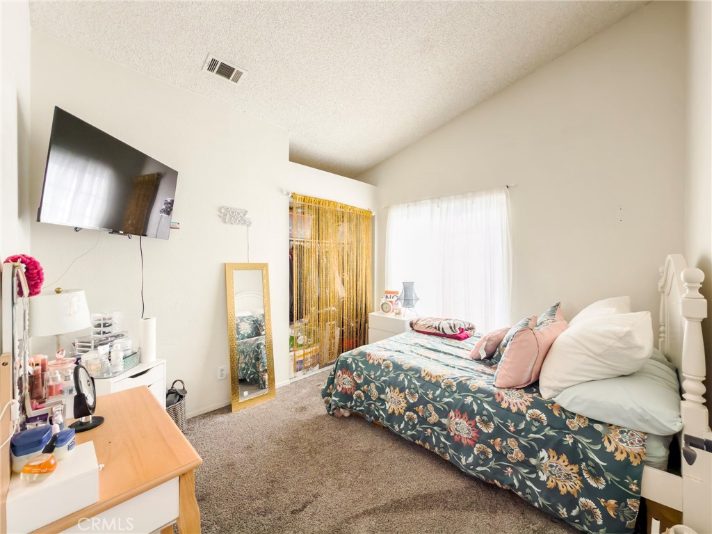 1738 The Willows Road San Jacinto, CA 92583 - Photo 25 of 34 a bedroom with a bed and flat screen tv