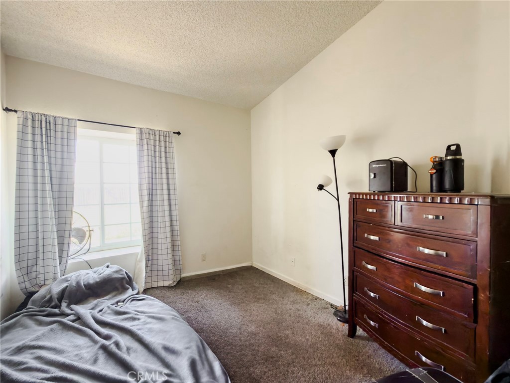 1738 The Willows Road San Jacinto, CA 92583 - Photo 26 of 34 a bedroom with a bed and a mirror