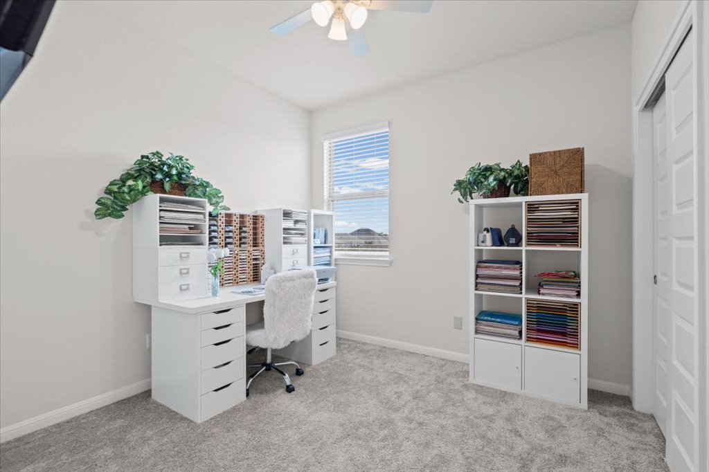 158 Gullivers Drive Elgin, TX 78621 - Photo 21 of 36 This bedroom is currently set up as a home office and crafting room. If you work from home or need a dedicated studio space, this is absolutely perfect.