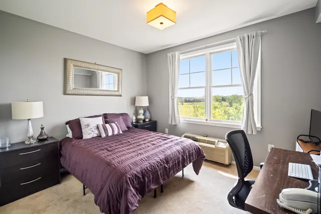 a bedroom with a bed and a desk