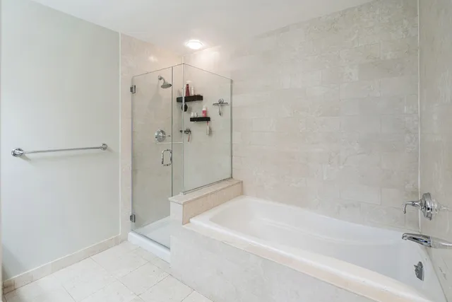 a bathroom with a bathtub and a shower