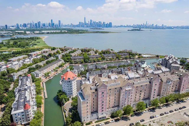 a view of a lake with a city skyline in the background