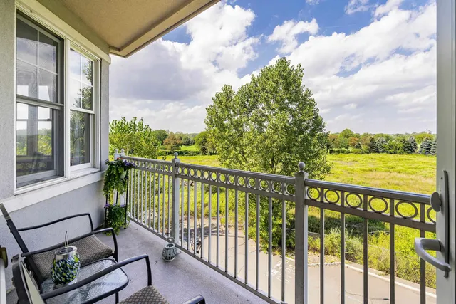 a view of a chair and tables in the balcony