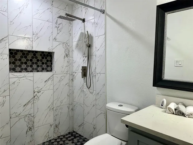 a bathroom with a sink toilet and shower