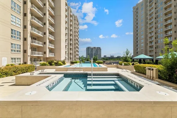 a view of swimming pool with outdoor seating and a building view