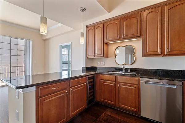 a kitchen with kitchen island granite countertop a sink stainless steel appliances and cabinets