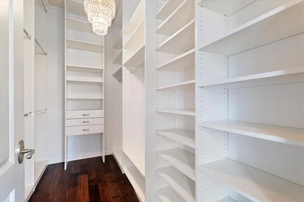 a view of walk in closet with empty racks
