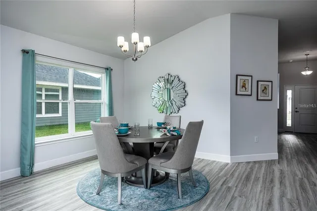 a view of a dining room with furniture and window