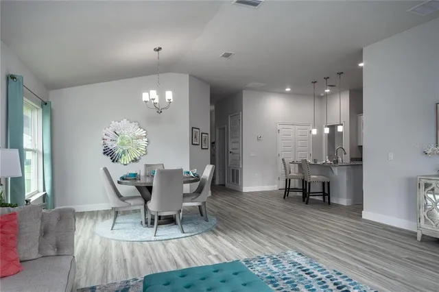 a dining room with furniture and chandelier