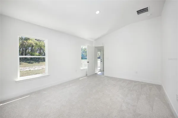 an empty room with windows and closet