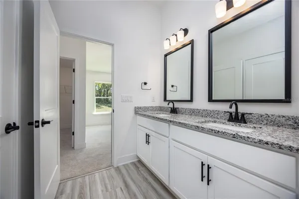 a bathroom with a double vanity sink and mirror