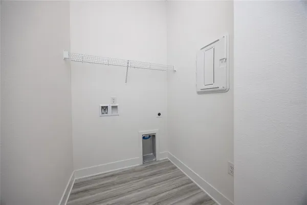 a view of a room with wooden floor