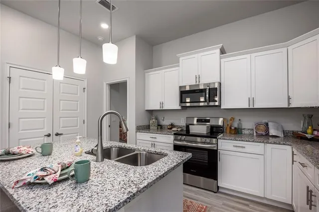 a kitchen with cabinets a sink and appliances