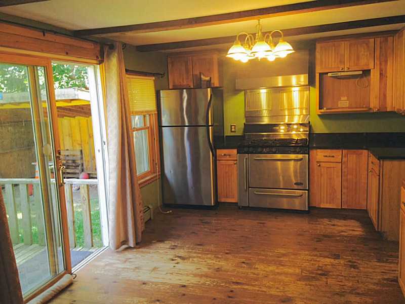 792 Maple Valley Road Coventry, RI 02816 - Photo 4 of 16 Kitchen. Wide pine floors need to be refinished. Slider to rear yard-perfect for cook outs!