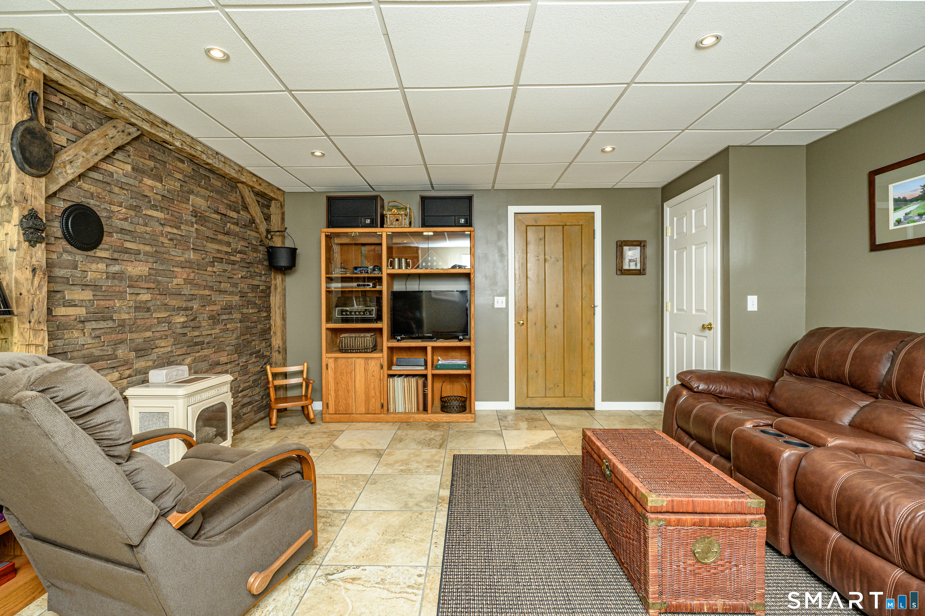 187 Chaplin Road Eastford, CT 06242 - Photo 35 of 40 Finished recreation room with gas stove. Walk-out to garage and/or workshop
